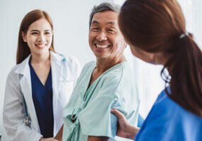 Asian doctor woman and nurse encourage disabled old man patient sitting on wheelchair at hospital, asian medical concept Asian doctor woman and nurse encourage disabled old man patient sitting on wheelchair at hospital, asian medical concept